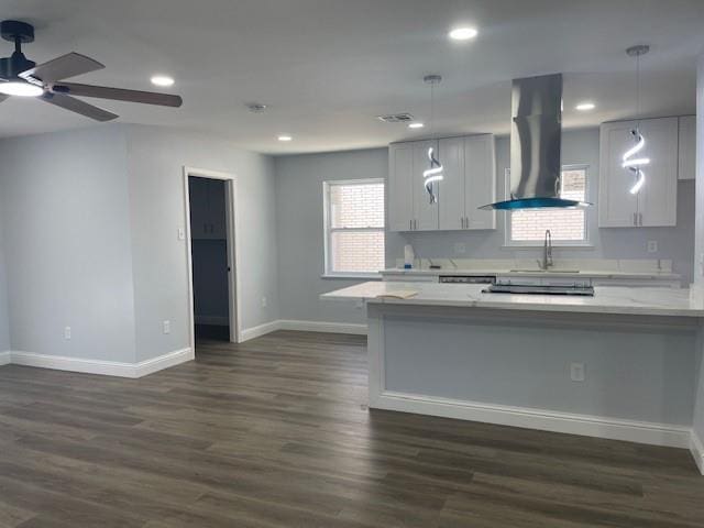 kitchen with recessed lighting, exhaust hood, baseboards, and dark wood-style flooring