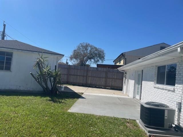 view of yard with central AC unit, a patio, and fence