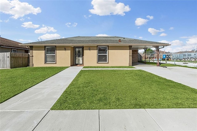 ranch-style house with an attached carport, a front lawn, fence, and stucco siding