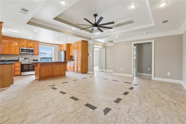 kitchen with open floor plan, visible vents, stainless steel appliances, and a tray ceiling