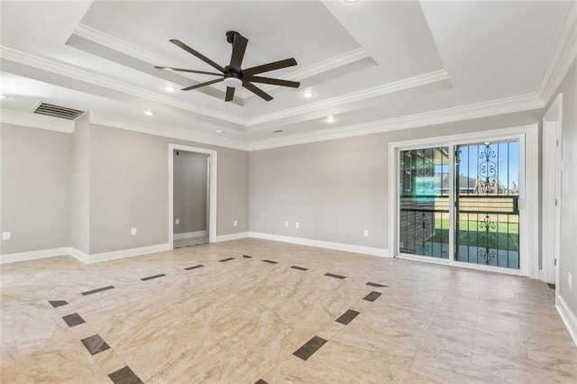 spare room featuring visible vents, ceiling fan, baseboards, and a tray ceiling