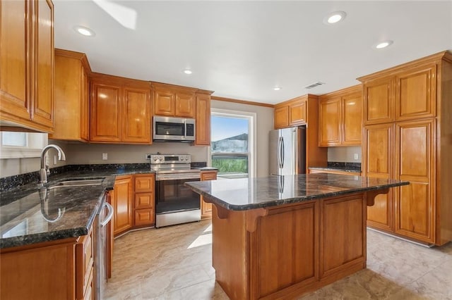 kitchen with a sink, visible vents, brown cabinets, and appliances with stainless steel finishes