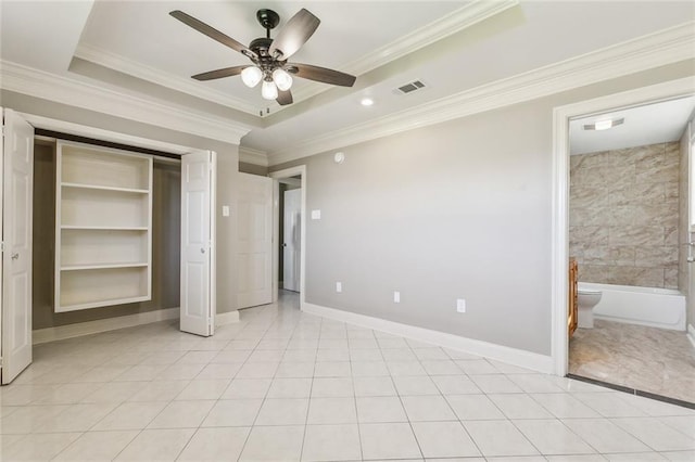 unfurnished bedroom featuring visible vents, ornamental molding, a tray ceiling, light tile patterned floors, and baseboards