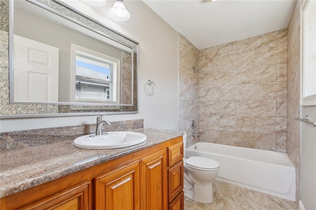 bathroom featuring shower / washtub combination, toilet, and vanity