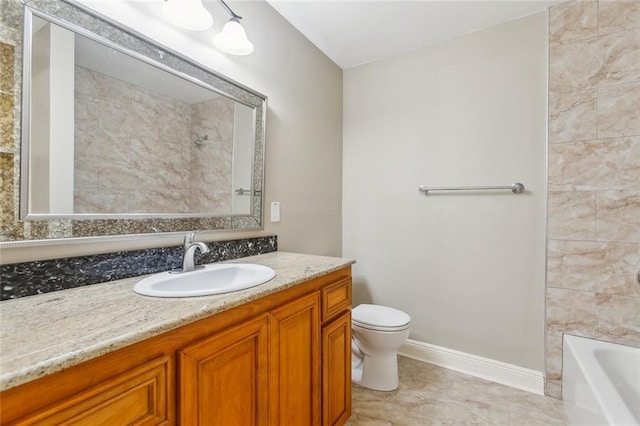 bathroom with vanity, toilet, baseboards, and tile patterned flooring