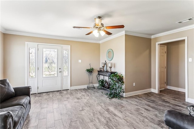 entryway with wood finished floors and ornamental molding