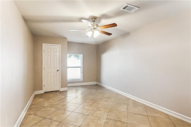 unfurnished room with light tile patterned floors, visible vents, ceiling fan, and baseboards