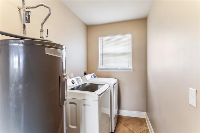 laundry room featuring electric water heater, separate washer and dryer, light tile patterned floors, baseboards, and laundry area