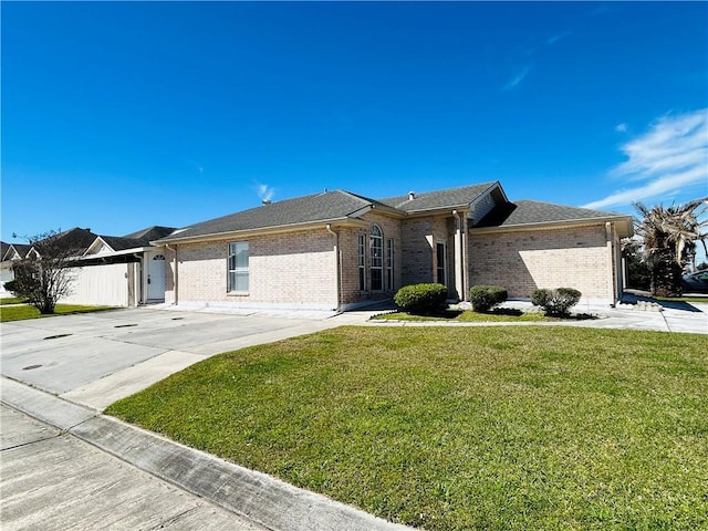 ranch-style home featuring a front yard, brick siding, and driveway