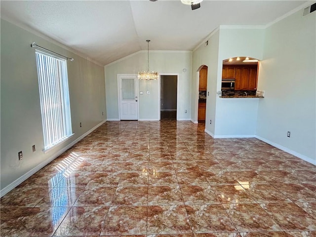 unfurnished living room with lofted ceiling, baseboards, arched walkways, and a chandelier