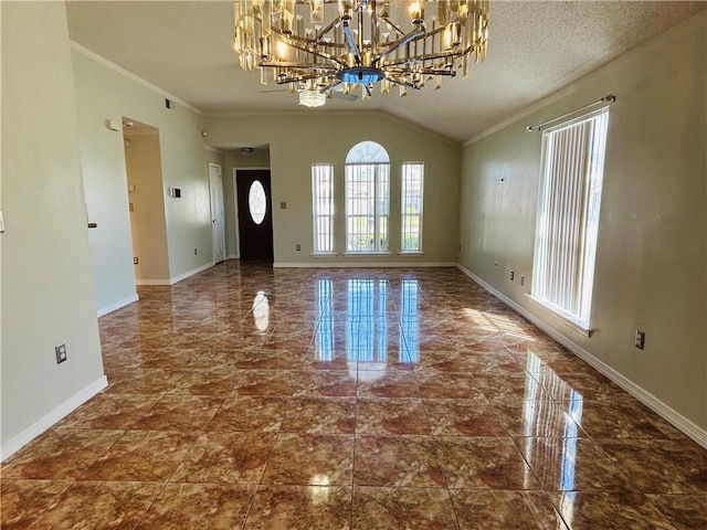 entryway with lofted ceiling, a textured ceiling, crown molding, and baseboards