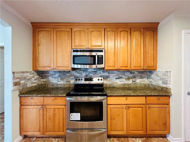 kitchen featuring dark stone counters, tasteful backsplash, and stainless steel appliances