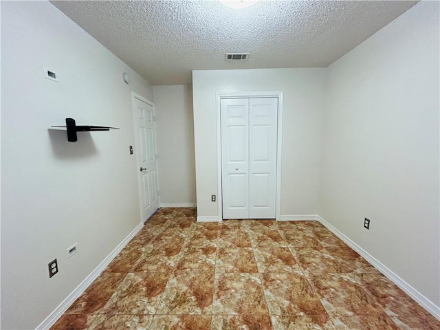 interior space featuring baseboards, visible vents, and a closet