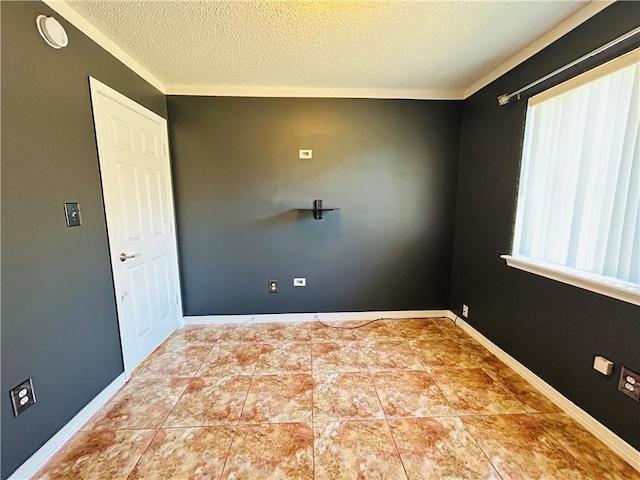 unfurnished room featuring plenty of natural light, a textured ceiling, and baseboards