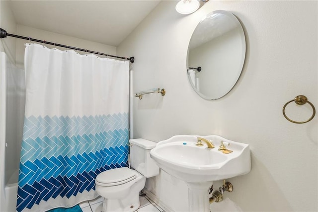 bathroom with a shower with curtain, tile patterned floors, and toilet