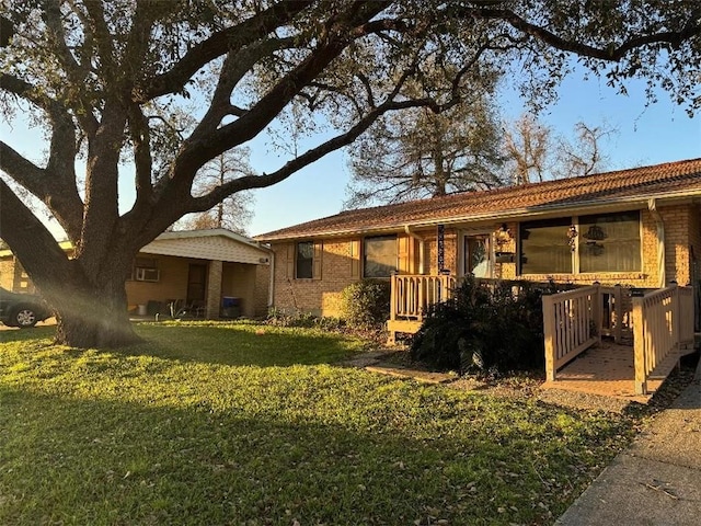 exterior space with brick siding and a yard