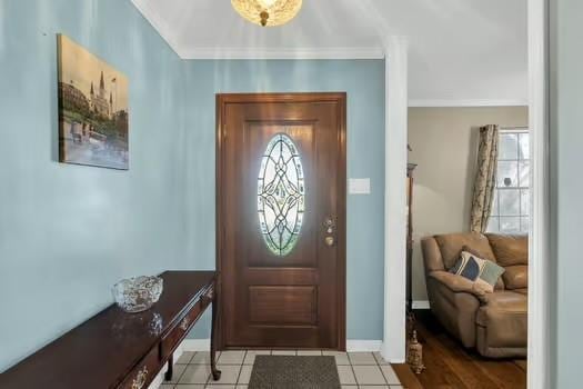 entrance foyer with light tile patterned floors and baseboards