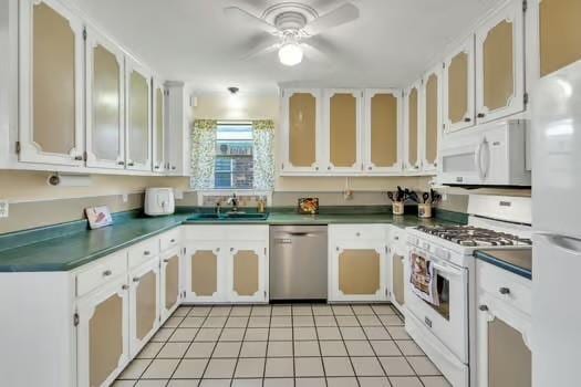 kitchen featuring white appliances, ceiling fan, a sink, glass insert cabinets, and dark countertops