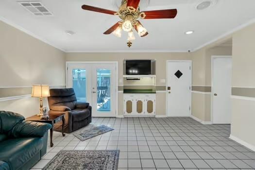 living room with light tile patterned floors, visible vents, french doors, and a ceiling fan