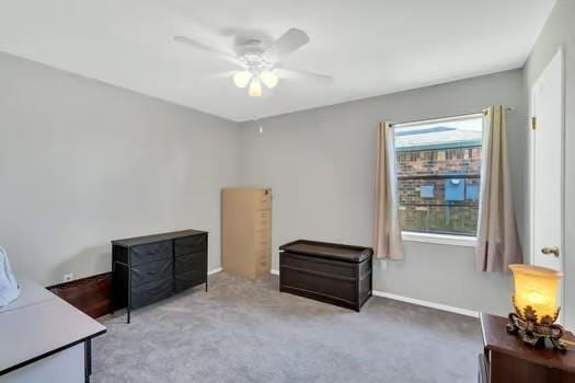 carpeted office with a ceiling fan