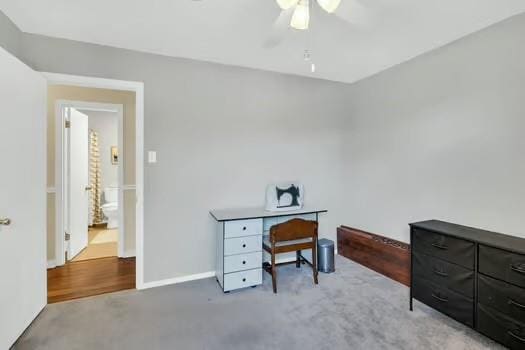 office area with baseboards and ceiling fan