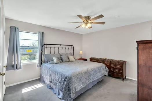 carpeted bedroom featuring a ceiling fan and baseboards