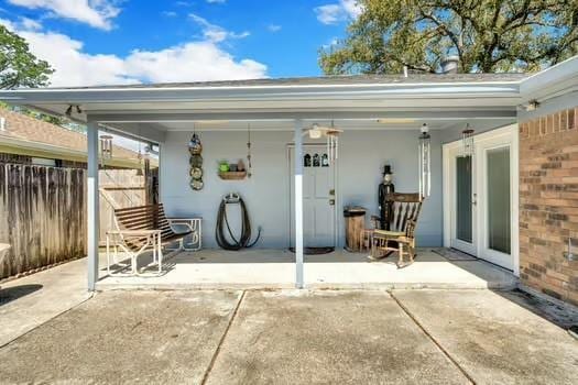 view of patio / terrace featuring french doors and fence