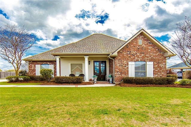 single story home featuring brick siding, roof with shingles, and a front yard