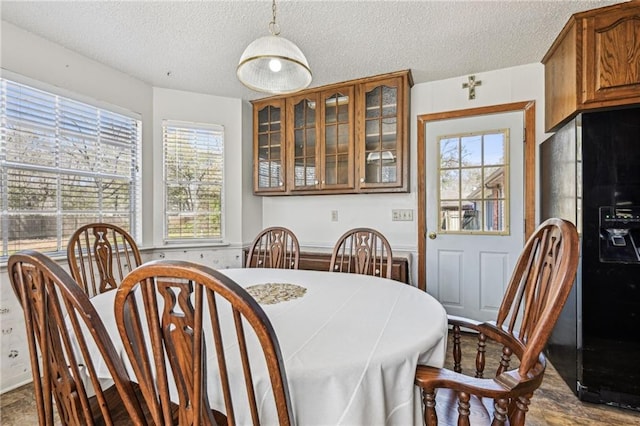 dining room featuring a textured ceiling