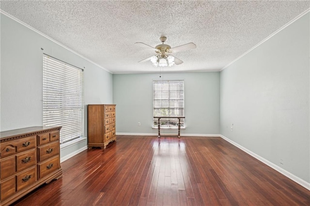 unfurnished room with crown molding, baseboards, dark wood-type flooring, ceiling fan, and a textured ceiling