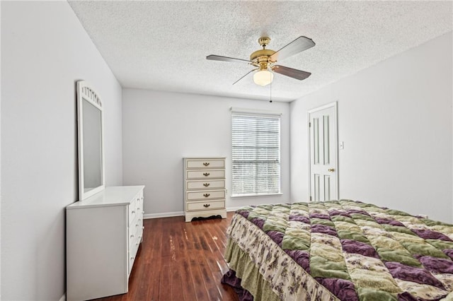 bedroom with baseboards, a textured ceiling, dark wood-type flooring, and a ceiling fan