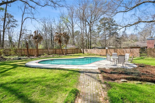 view of swimming pool with a yard, a fenced in pool, a patio, and a fenced backyard