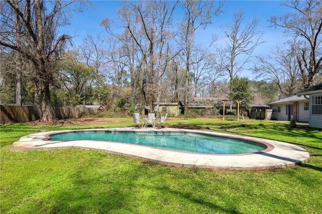 view of pool with a fenced in pool, a lawn, and fence