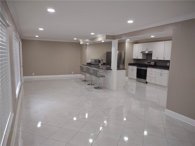 kitchen featuring stainless steel electric range oven, refrigerator, ornamental molding, under cabinet range hood, and dark countertops