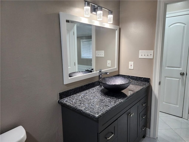 half bathroom with vanity and toilet