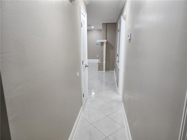 hall with baseboards and light tile patterned flooring