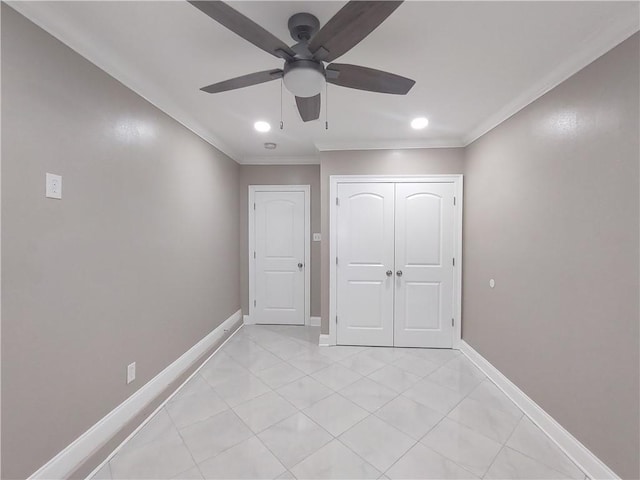 unfurnished bedroom with baseboards, ornamental molding, light tile patterned floors, a closet, and a ceiling fan