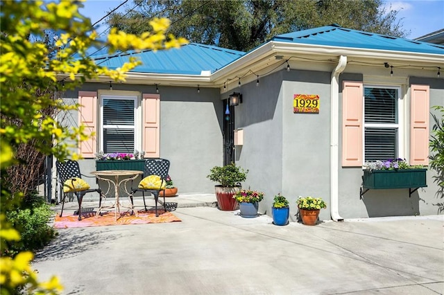 view of side of home with a patio area and stucco siding