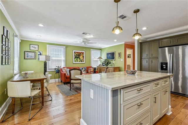 kitchen featuring visible vents, light wood-style floors, open floor plan, and stainless steel fridge with ice dispenser