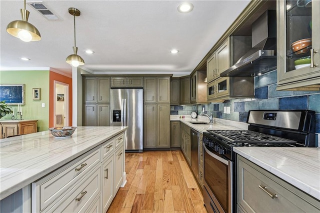 kitchen with light stone countertops, visible vents, stainless steel appliances, light wood-style floors, and wall chimney range hood