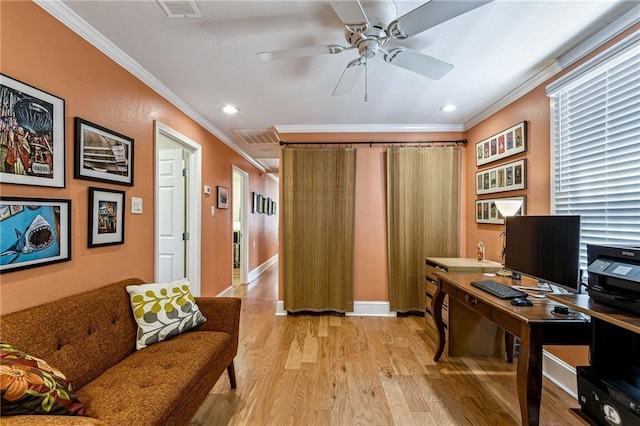 office space featuring ceiling fan, light wood-style floors, visible vents, and ornamental molding