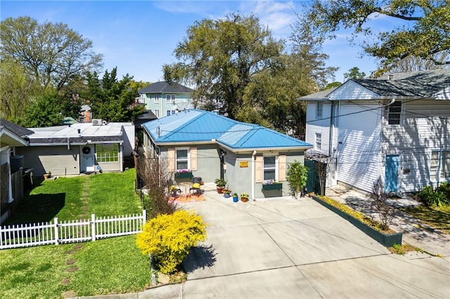 view of front of home featuring concrete driveway, a front yard, a fenced front yard, and stucco siding