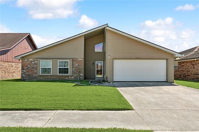 mid-century modern home with brick siding, an attached garage, concrete driveway, and a front lawn