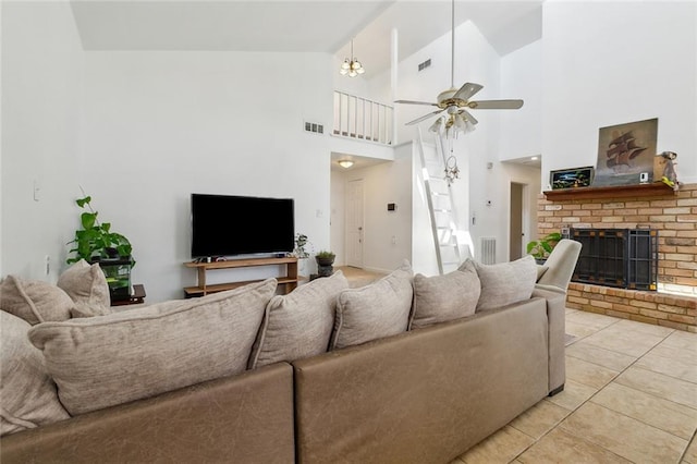 living room with vaulted ceiling, a brick fireplace, and visible vents