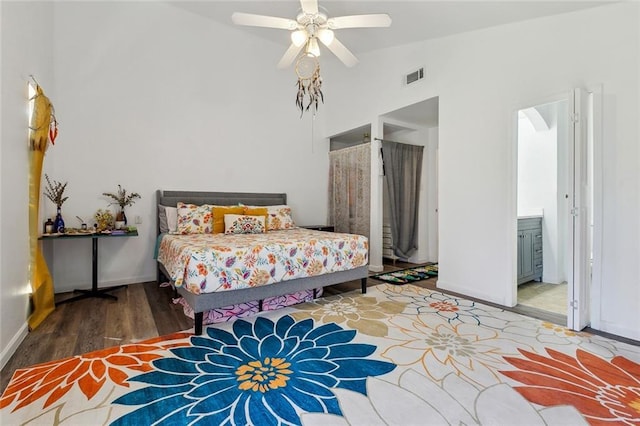 bedroom featuring visible vents, ceiling fan, baseboards, wood finished floors, and high vaulted ceiling