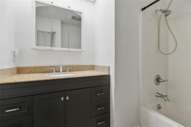 bathroom with vanity and shower / washtub combination