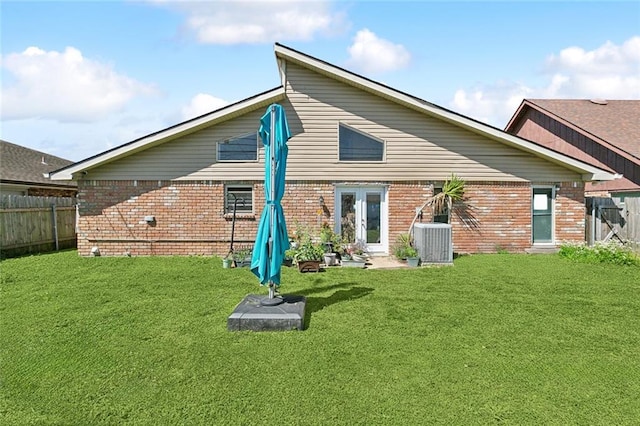 rear view of property featuring brick siding, french doors, fence private yard, and central AC