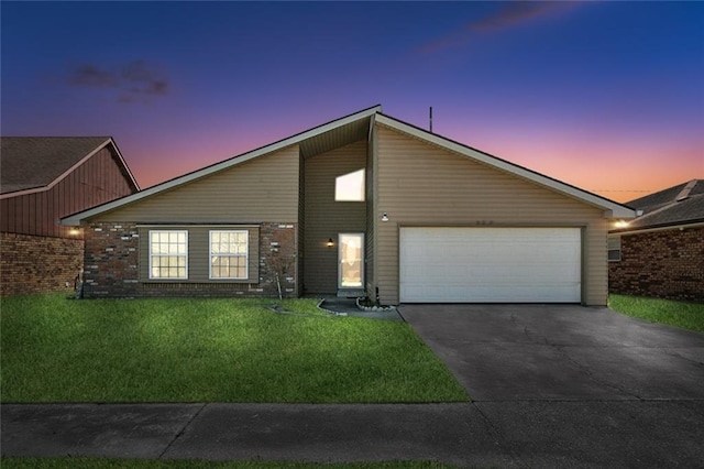 mid-century modern home featuring brick siding, a garage, concrete driveway, and a front yard