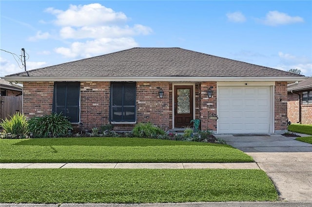 single story home featuring brick siding, a shingled roof, a front lawn, concrete driveway, and a garage