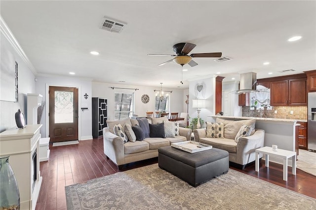 living area featuring dark wood finished floors, crown molding, and visible vents